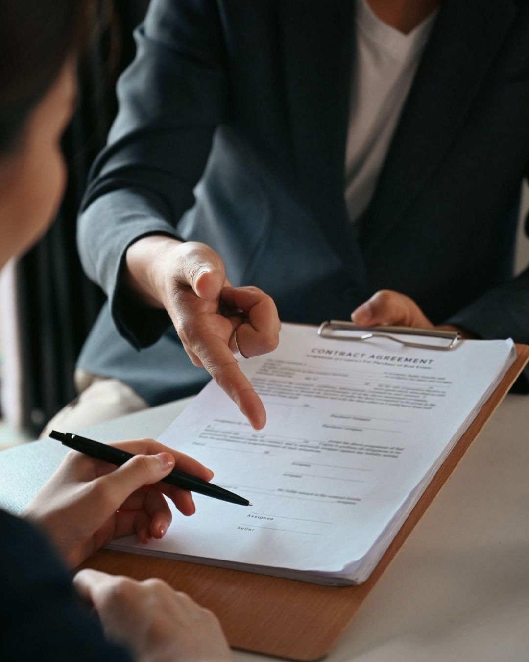 Advisor and client reviewing financial planning documents together at a table in a bright office